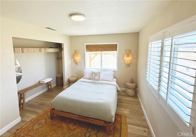 1388 Fortuna Ave, Landers, CA 92285 - bedroom with wood finished floors, a closet, and a textured ceiling