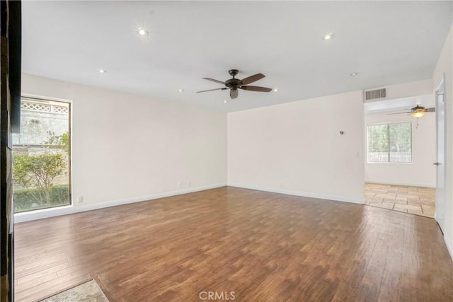 unfurnished room with ceiling fan and wood-type flooring