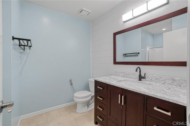 bathroom featuring toilet, vanity, tile patterned floors, and a shower with shower door