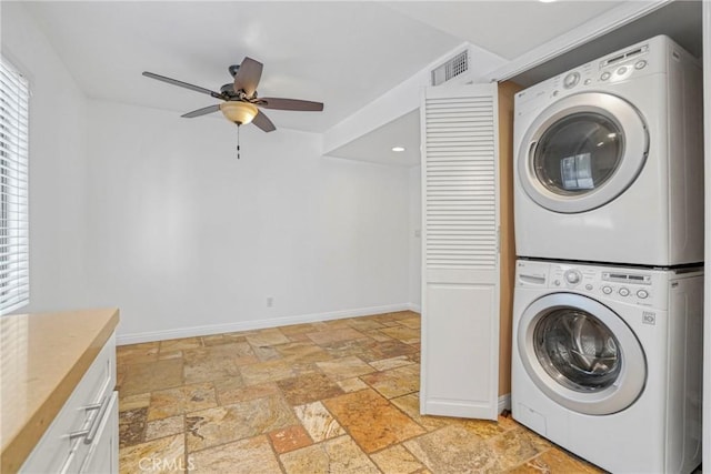 clothes washing area featuring stacked washer and clothes dryer and ceiling fan