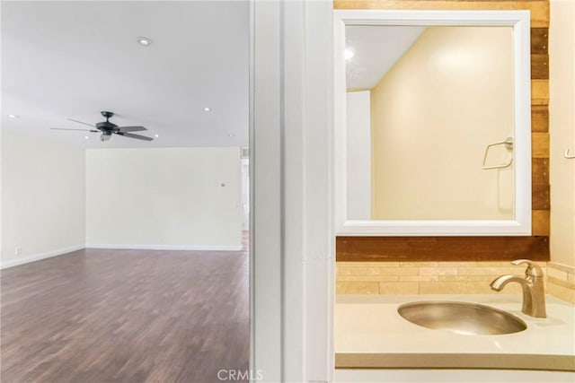 bathroom featuring sink, wood-type flooring, and ceiling fan