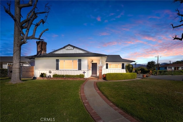 ranch-style home with a yard