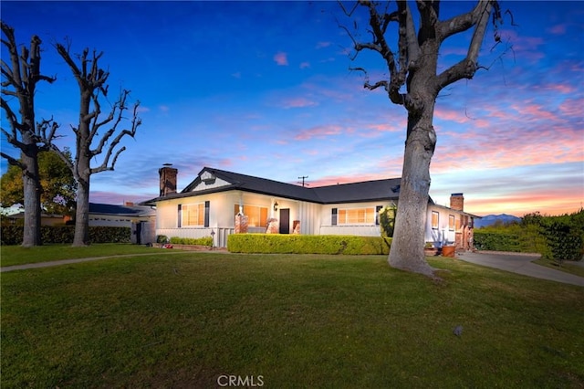 ranch-style home featuring a yard