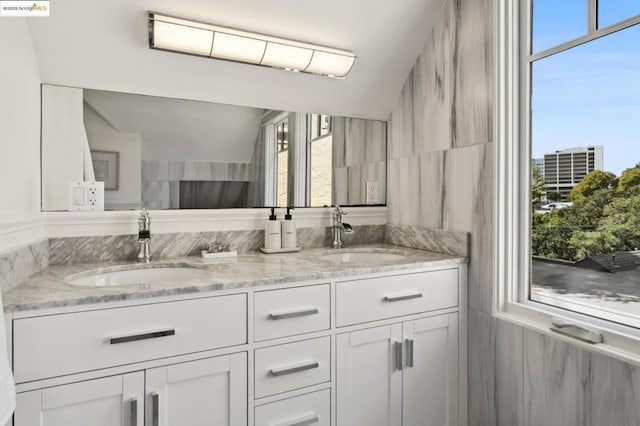 bathroom featuring tile walls, vaulted ceiling, and vanity