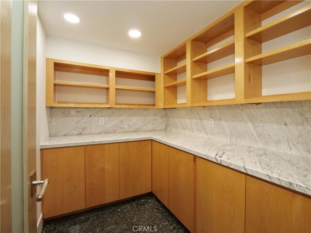 kitchen with tasteful backsplash and light stone countertops