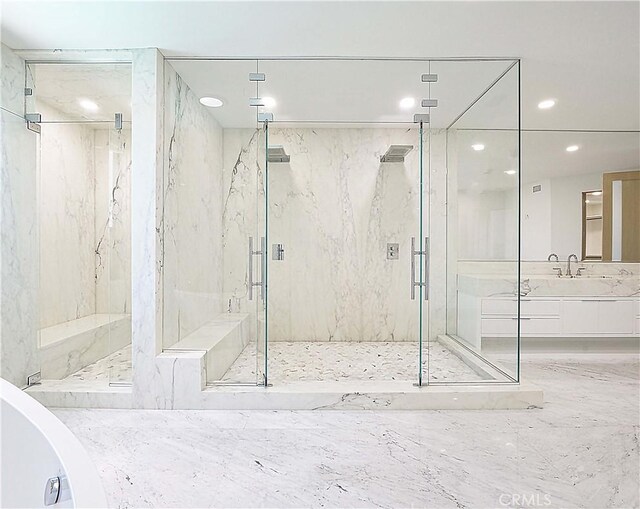 bathroom with a shower with door and vanity