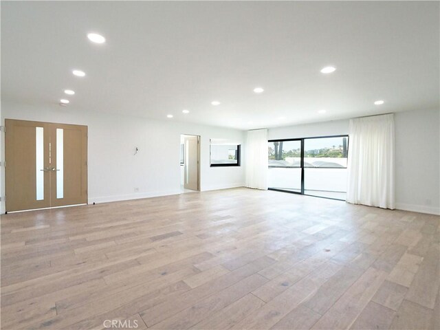 unfurnished room with light hardwood / wood-style flooring