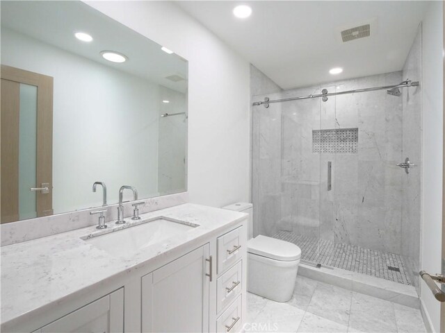 bathroom with toilet, an enclosed shower, and vanity