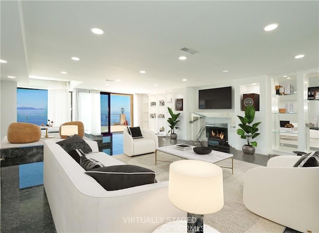 living room with a wall of windows and built in shelves