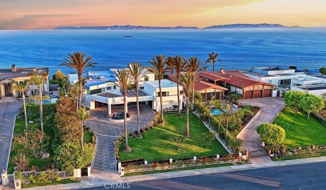 aerial view at dusk with a water view