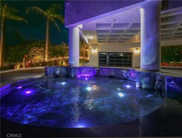 view of pool featuring a hot tub and pool water feature