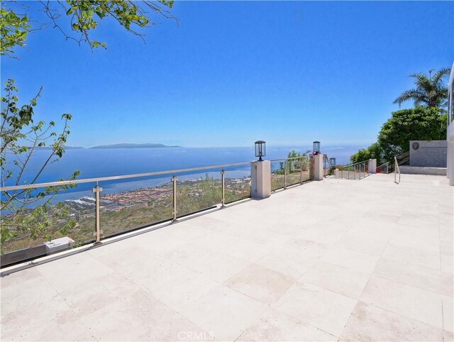 view of patio featuring a water view