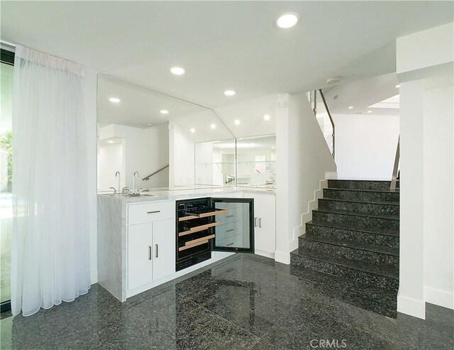 bar featuring white cabinets and beverage cooler