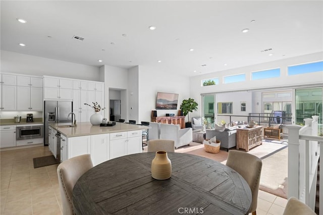 tiled dining space featuring sink