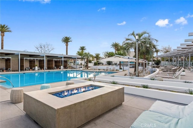 community pool featuring a fire pit and a patio area