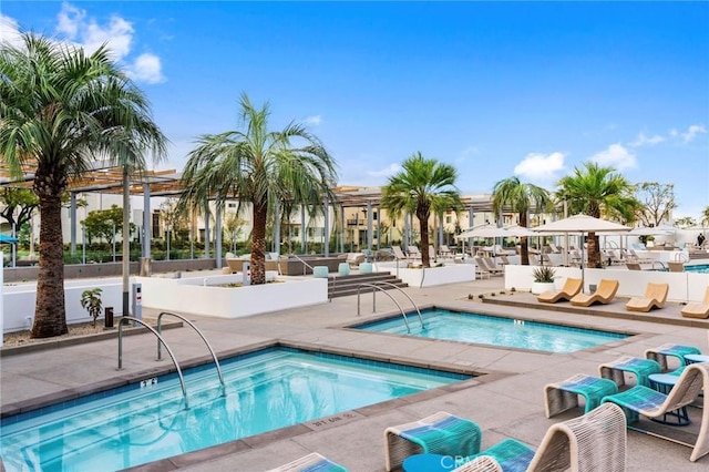 view of pool with a community hot tub and a patio