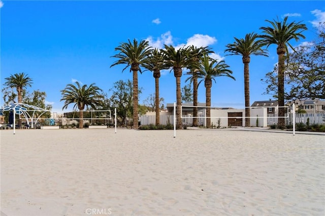 view of home's community featuring volleyball court and fence