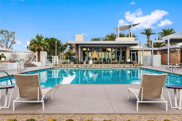 pool featuring fence and a patio