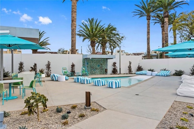 view of pool with a fenced backyard, a fenced in pool, and a patio