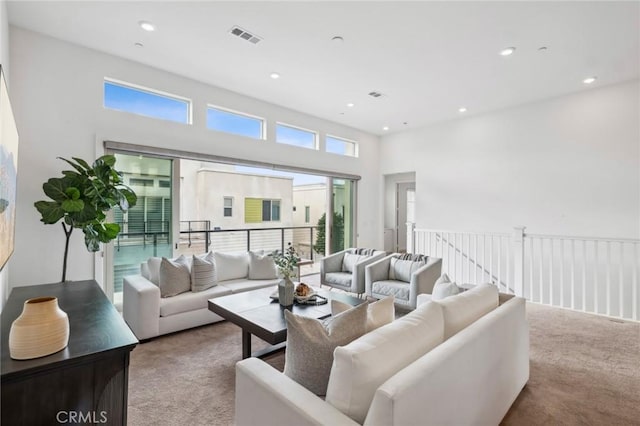 carpeted living room featuring recessed lighting and visible vents