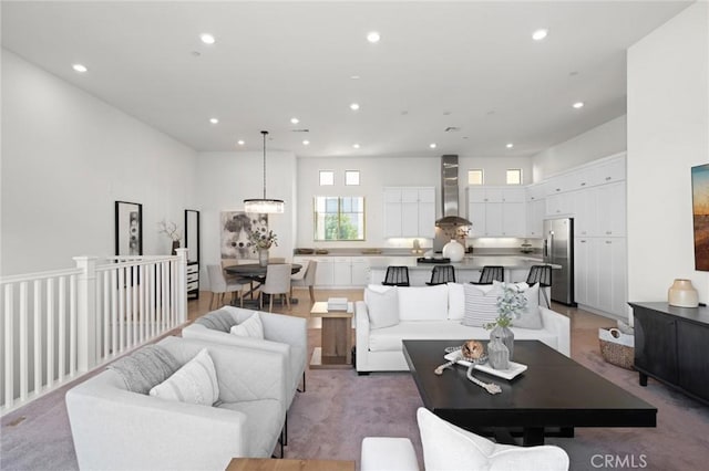 living room with a high ceiling and recessed lighting