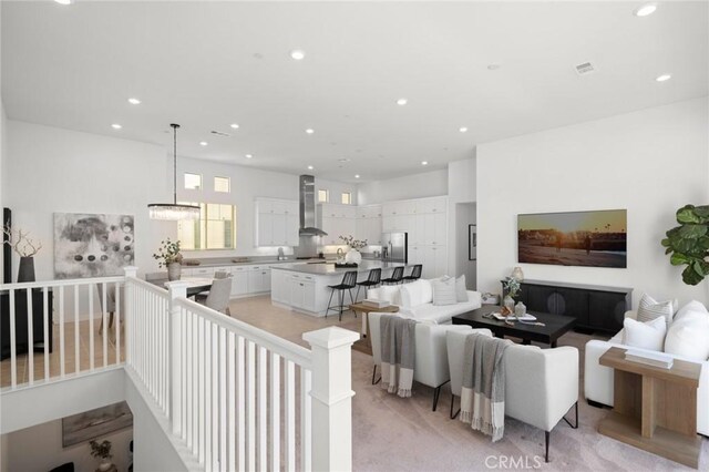 living area featuring visible vents and recessed lighting