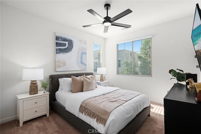 bedroom with baseboards, a ceiling fan, and carpet flooring