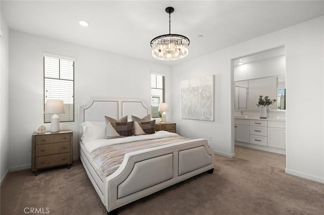 bedroom featuring light carpet, a chandelier, connected bathroom, and baseboards