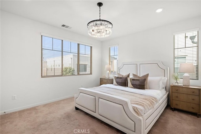 bedroom with a chandelier, carpet, visible vents, and baseboards