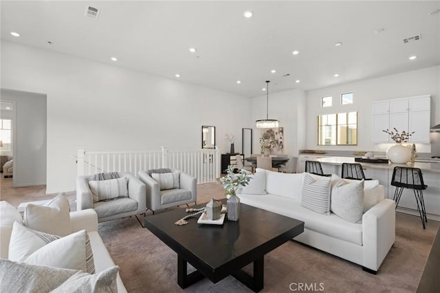 living area featuring visible vents and recessed lighting