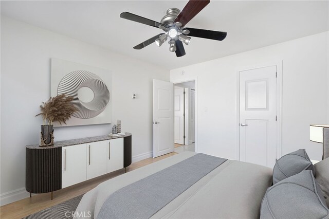 bedroom with ceiling fan and light hardwood / wood-style flooring