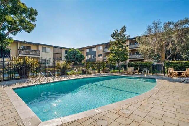 view of swimming pool featuring a patio area