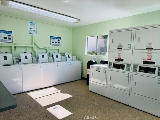 laundry area with separate washer and dryer and stacked washer / drying machine