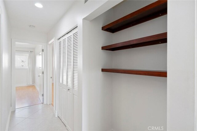 hall with light tile patterned flooring