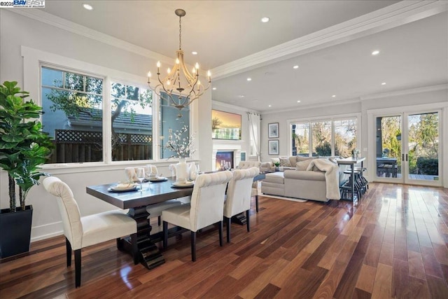 dining area featuring ornamental molding, dark hardwood / wood-style floors, and a chandelier