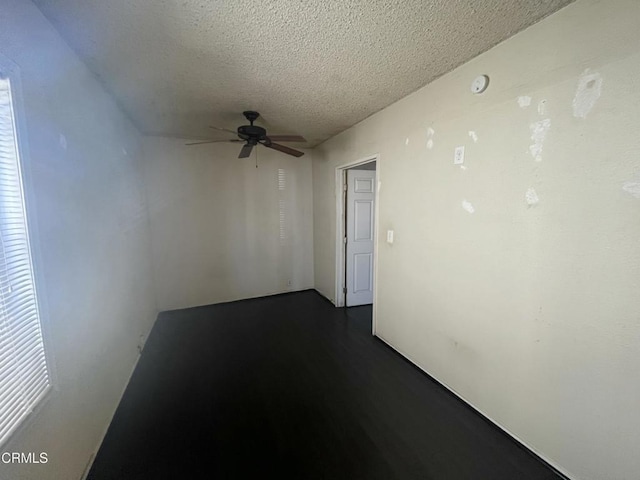 unfurnished room featuring a textured ceiling and ceiling fan