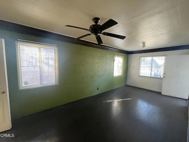 unfurnished room featuring ceiling fan and dark hardwood / wood-style floors