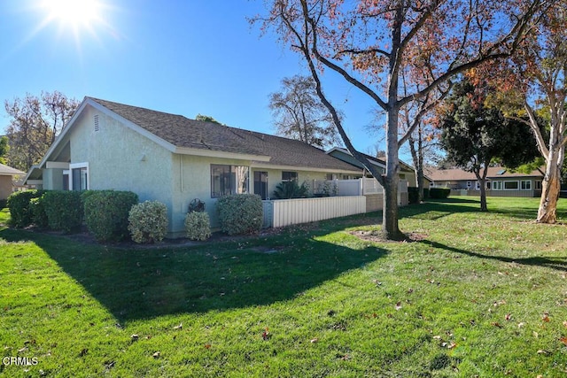 view of side of property with a lawn