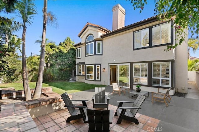 rear view of house with a patio and a yard