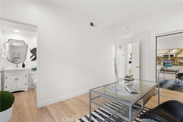 office space featuring sink and hardwood / wood-style floors