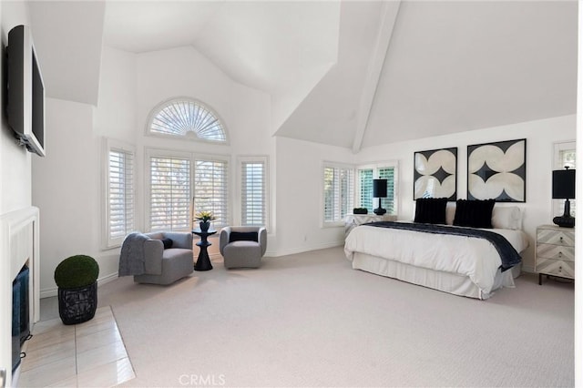 carpeted bedroom featuring high vaulted ceiling and beamed ceiling