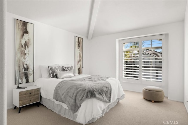 bedroom featuring light colored carpet and vaulted ceiling with beams