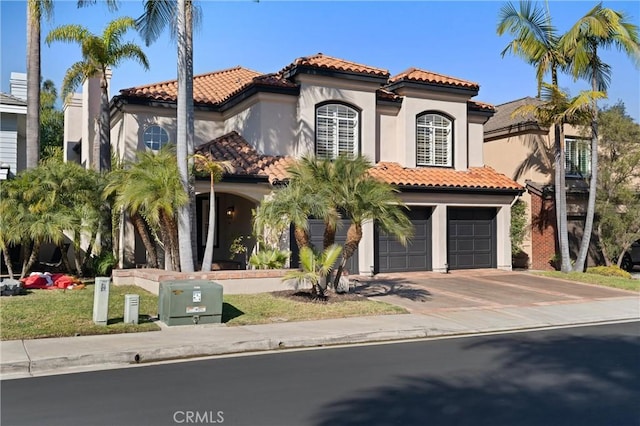 mediterranean / spanish home with a garage