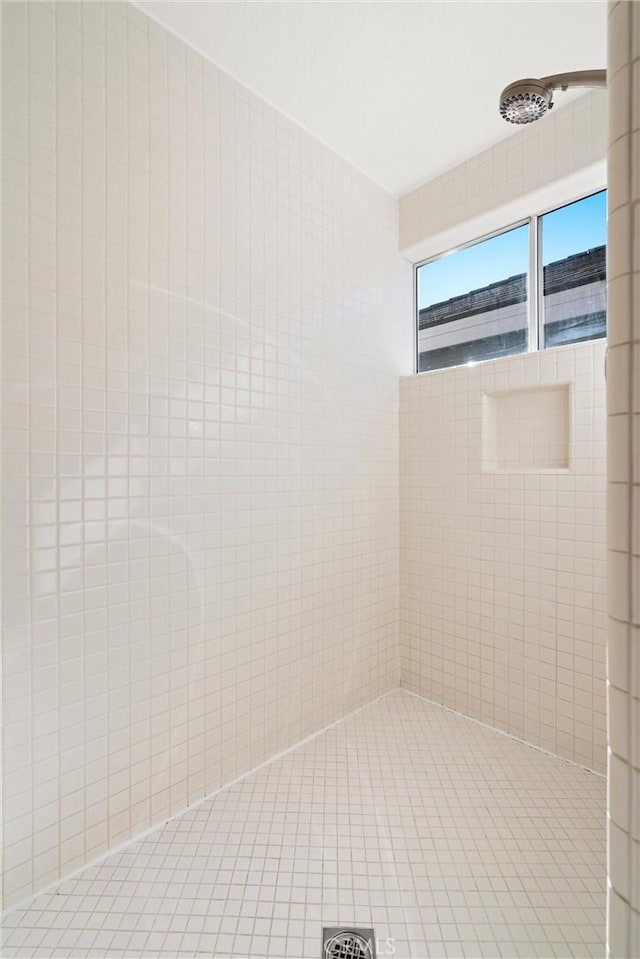 bathroom with tiled shower