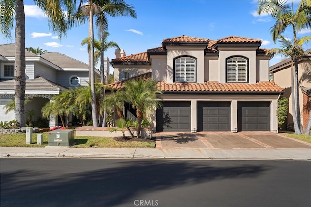 mediterranean / spanish-style house with a garage