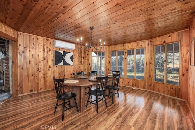 dining room with wood-type flooring, wooden ceiling, a notable chandelier, and a wall mounted AC