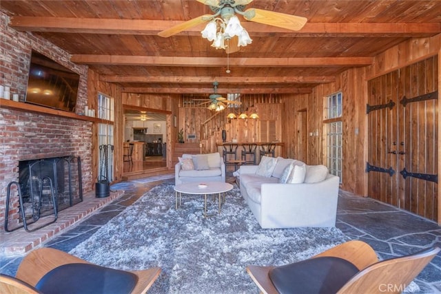 living room featuring wooden walls, wooden ceiling, and beamed ceiling