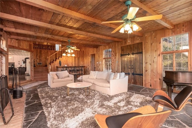 living room with ceiling fan, beam ceiling, wooden walls, and wooden ceiling