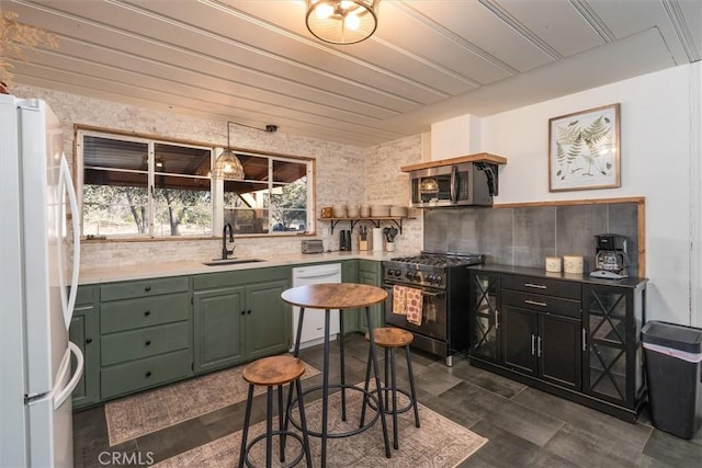 kitchen with appliances with stainless steel finishes, decorative backsplash, and sink