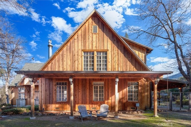 rear view of property featuring a yard